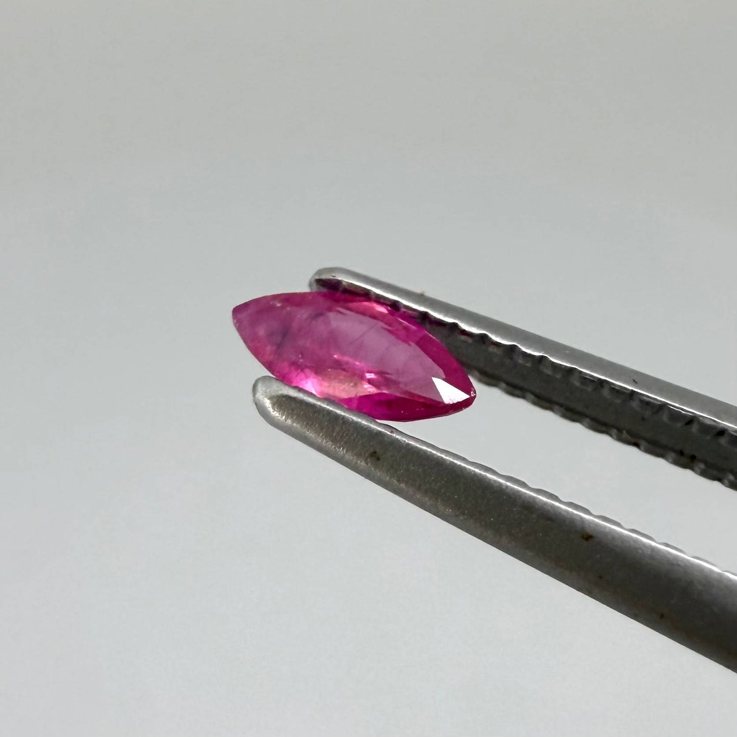 Two reddish-pink marquise-cut rubies, with a total of 0.33 ct, eye-clean appearance with fine natural inclusions