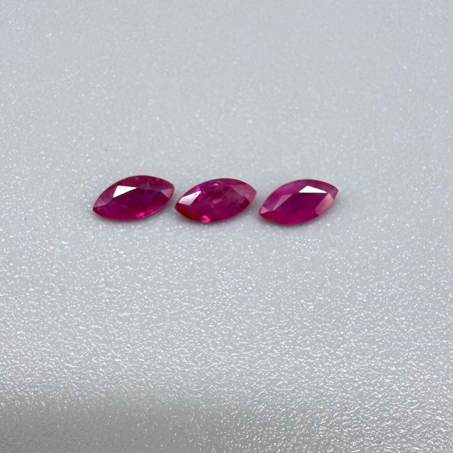 Three marquise-cut pink-red ruby, eye-clean to slightly silky appearance with fine inclusions