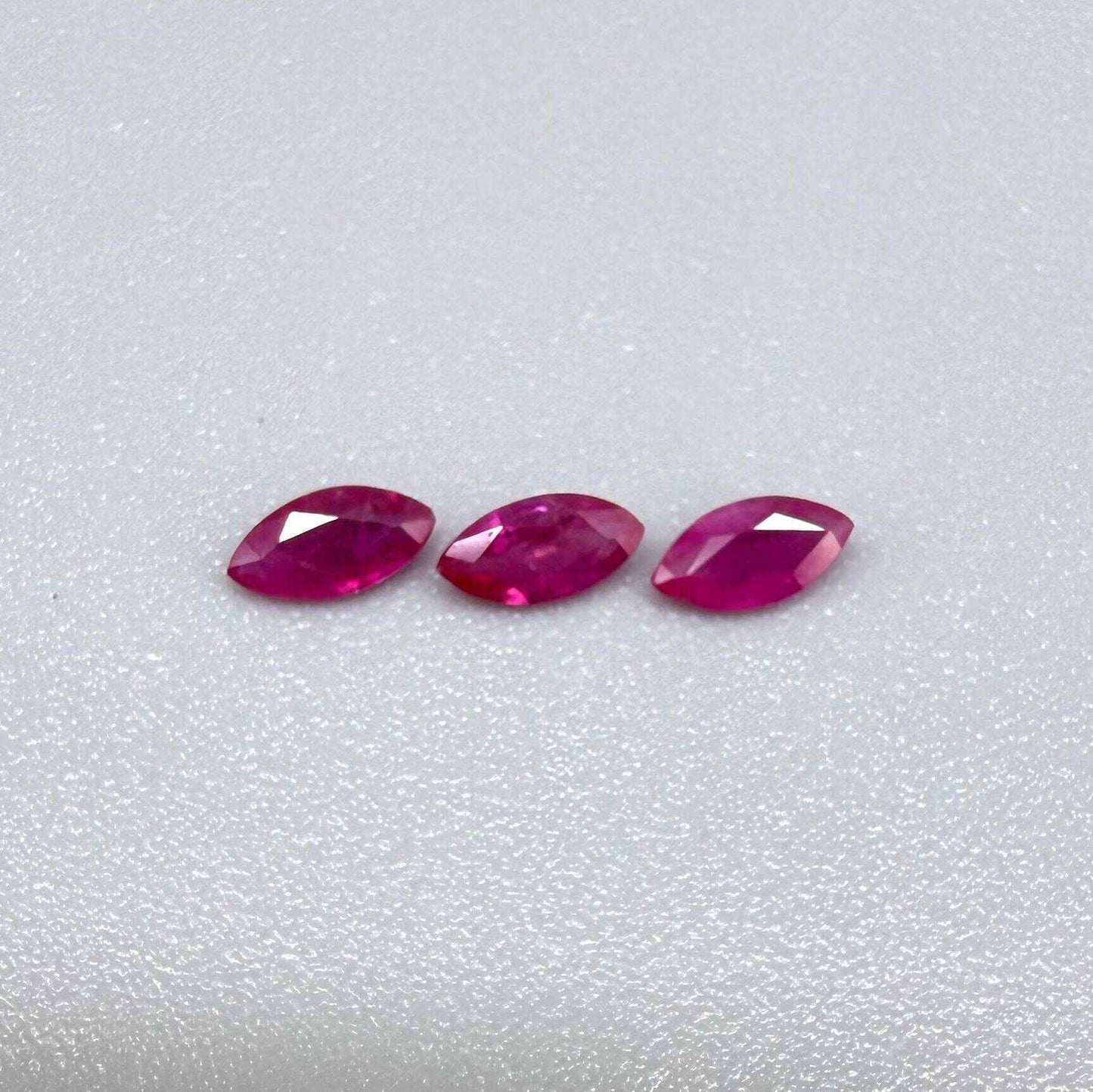 Three marquise-cut pink-red ruby, eye-clean to slightly silky appearance with fine inclusions