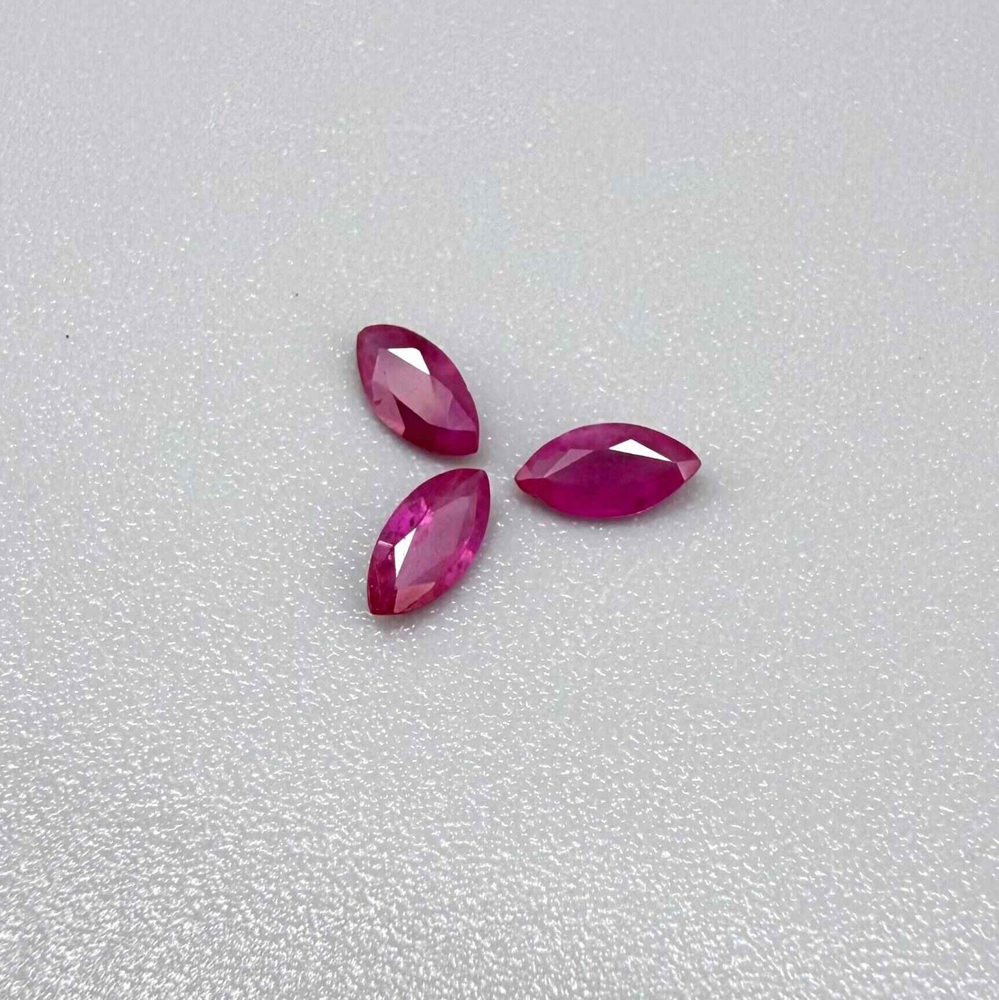 Three marquise-cut pink-red ruby, eye-clean to slightly silky appearance with fine inclusions