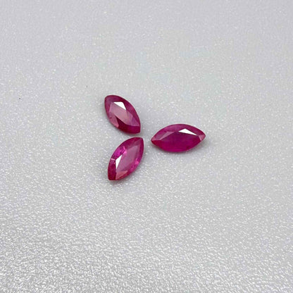 Three marquise-cut pink-red ruby, eye-clean to slightly silky appearance with fine inclusions