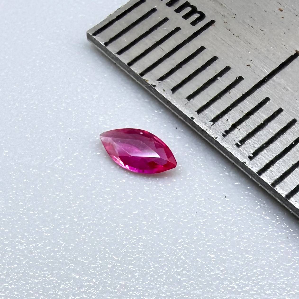 0.09 ct marquise-cut magenta-red ruby, eye-clean appearance with no visible inclusions with naked eye