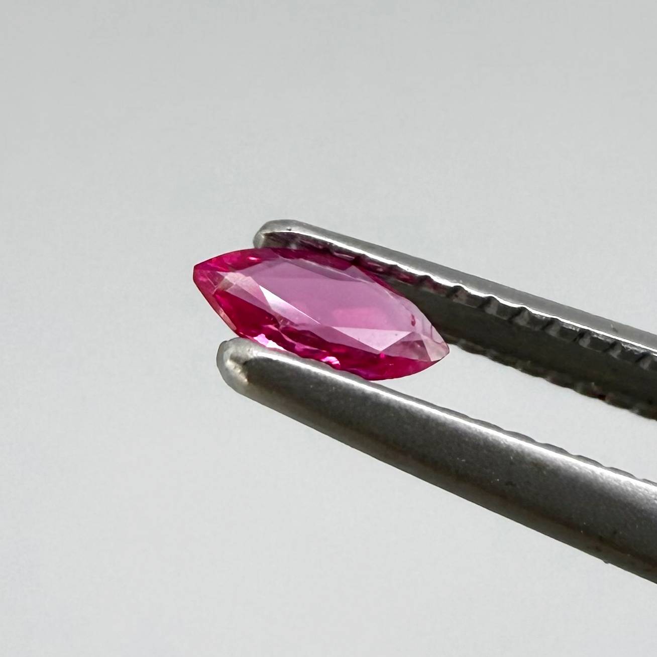 0.09 ct marquise-cut magenta-red ruby, eye-clean appearance with no visible inclusions with naked eye