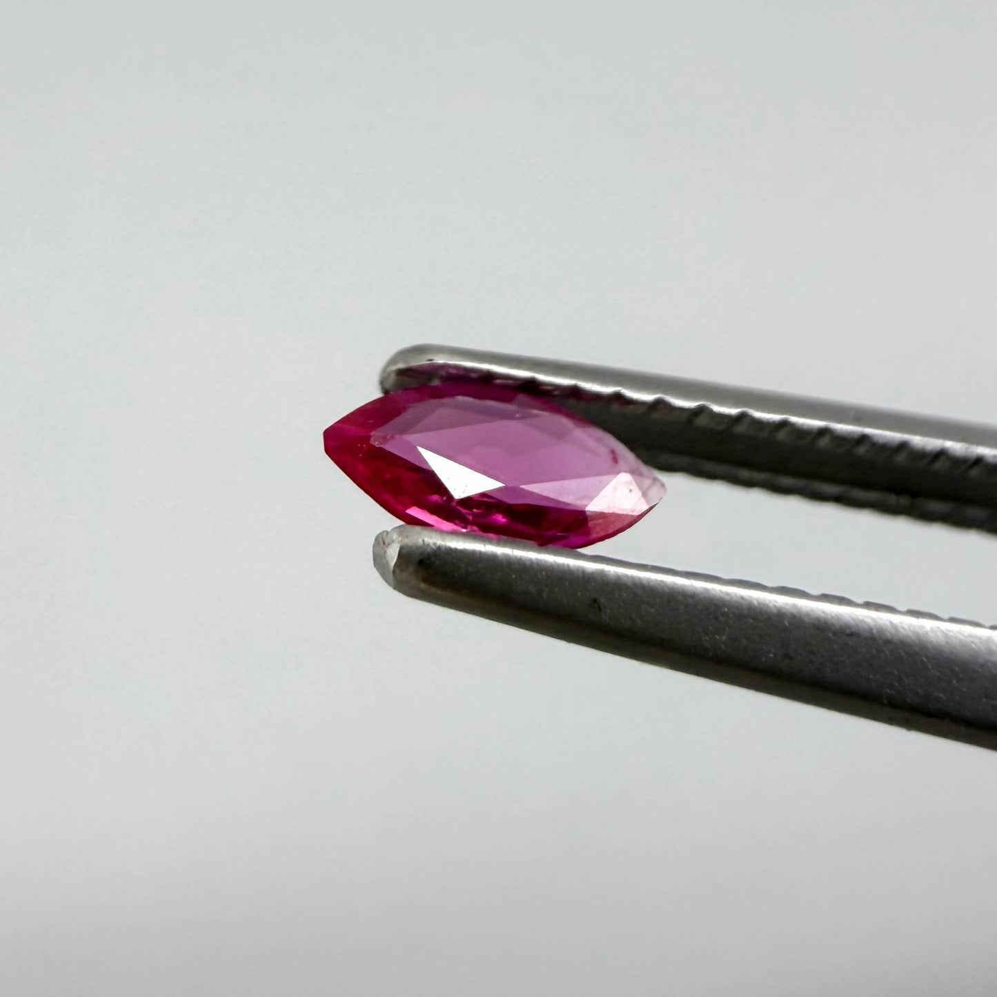 0.09 ct marquise-cut magenta-red ruby, eye-clean appearance with no visible inclusions with naked eye