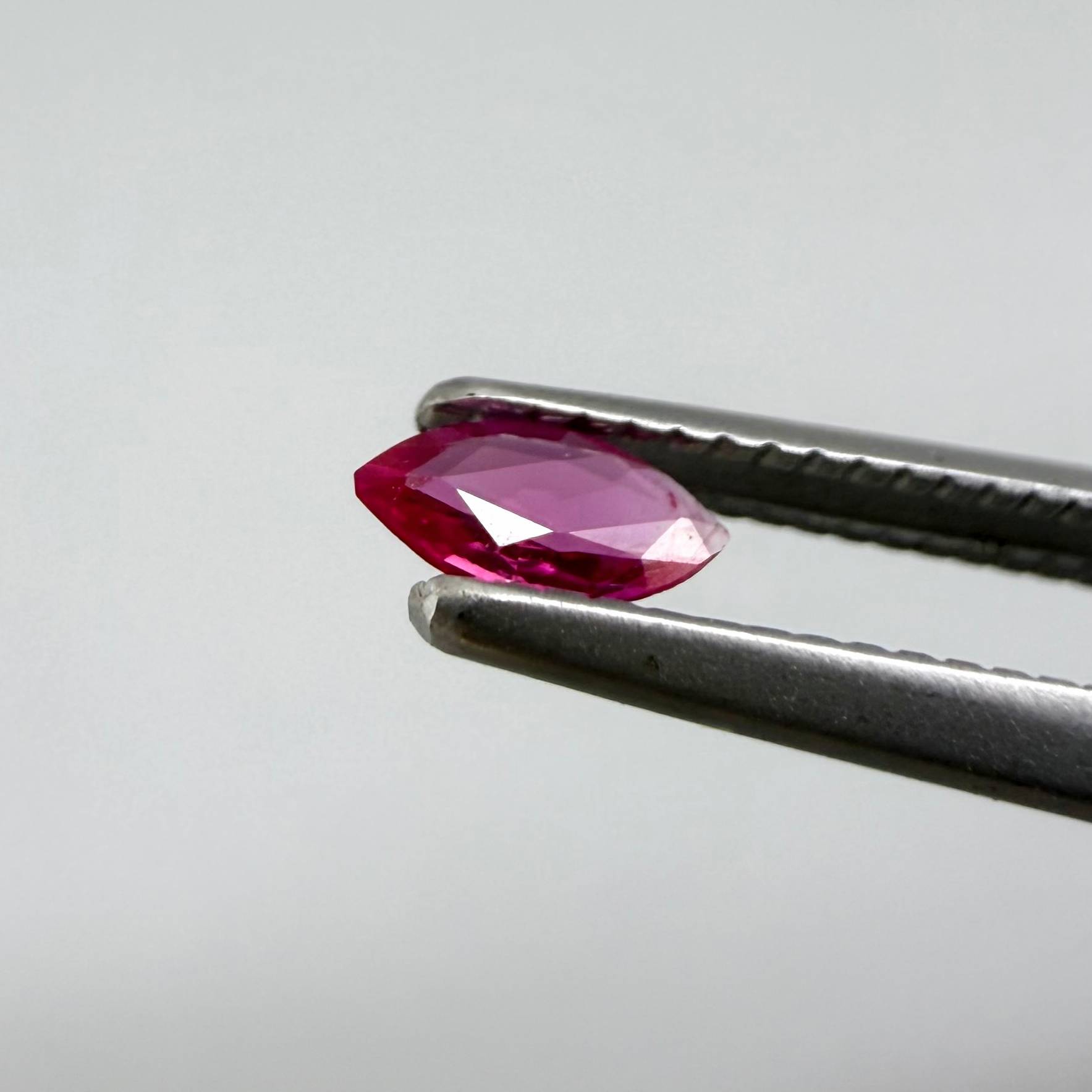 0.09 ct marquise-cut magenta-red ruby, eye-clean appearance with no visible inclusions with naked eye