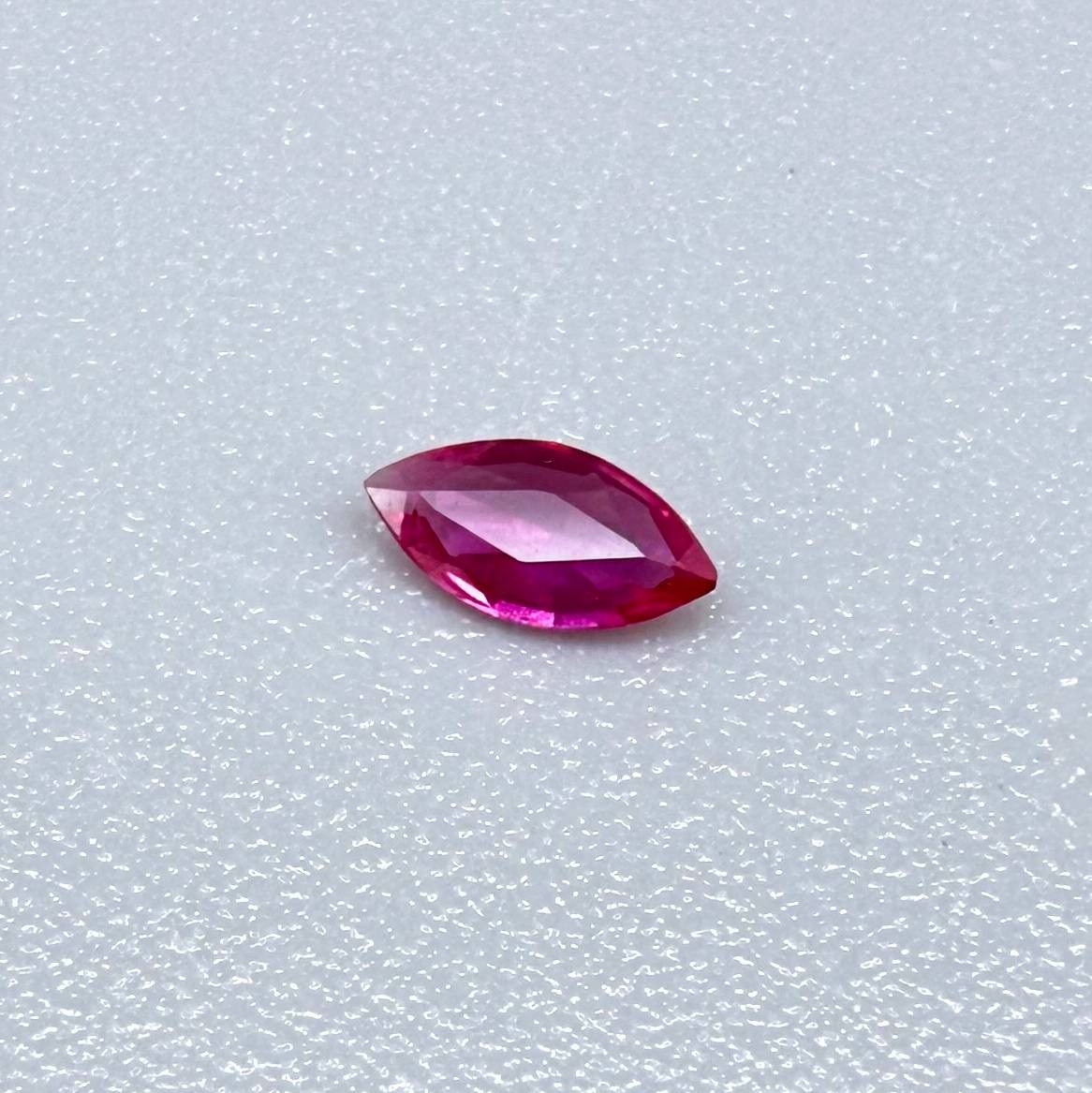 0.09 ct marquise-cut magenta-red ruby, eye-clean appearance with no visible inclusions with naked eye