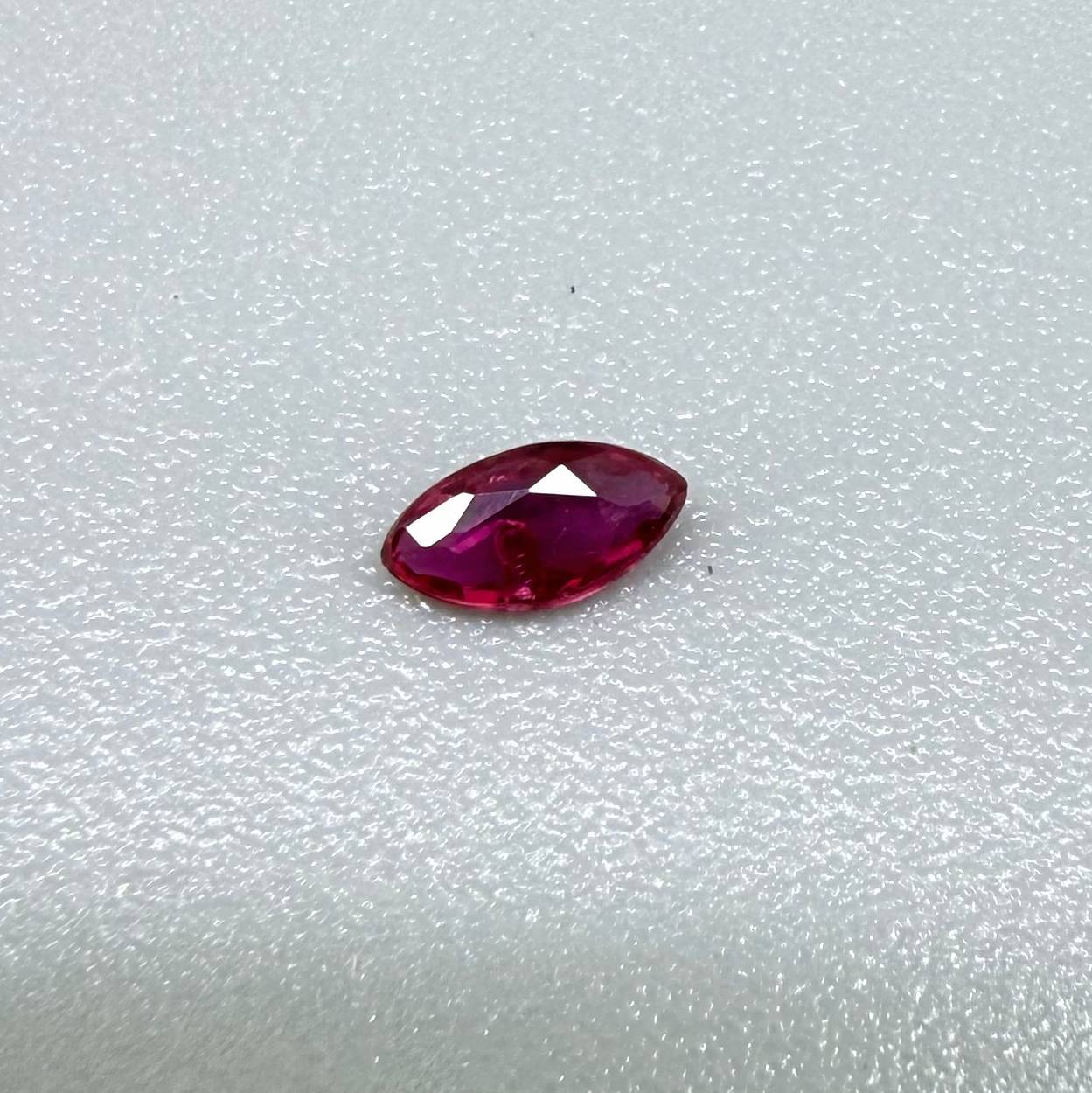 0.13 ct marquise-cut vivid pink-red ruby from Myanmar, eye-clean appearance