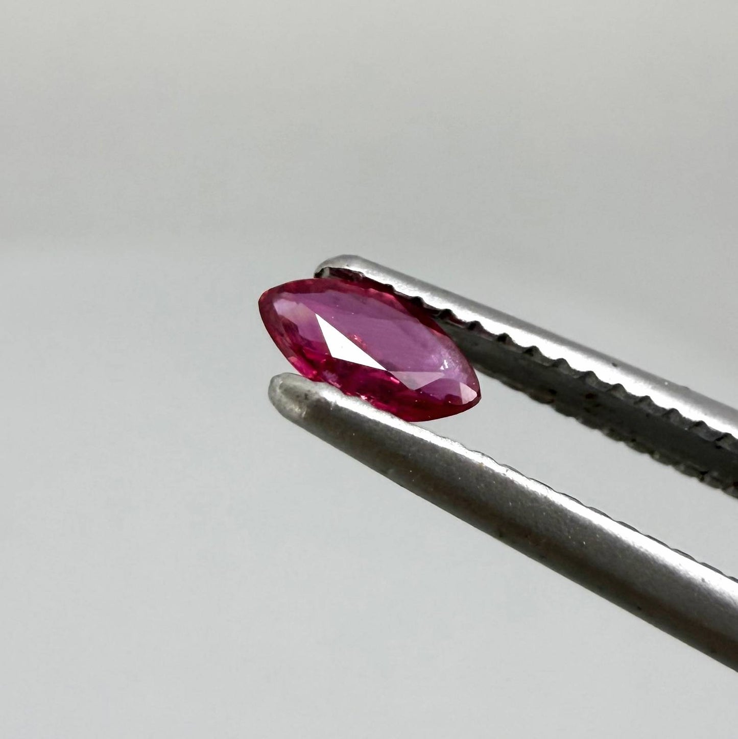 0.13 ct marquise-cut vivid pink-red ruby from Myanmar, eye-clean appearance