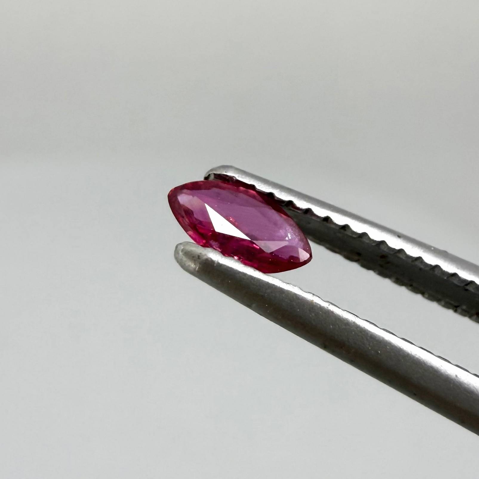 0.13 ct marquise-cut vivid pink-red ruby from Myanmar, eye-clean appearance