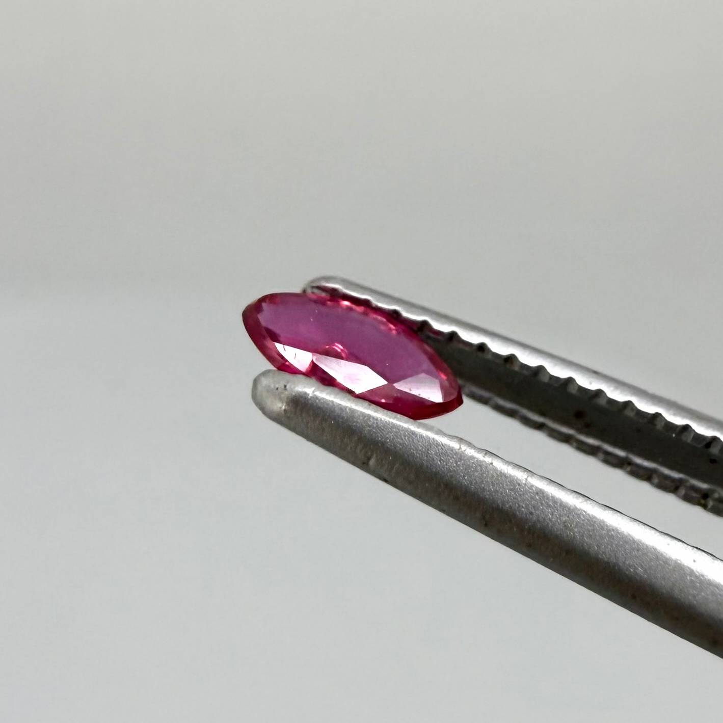 0.13 ct marquise-cut vivid pink-red ruby from Myanmar, eye-clean appearance