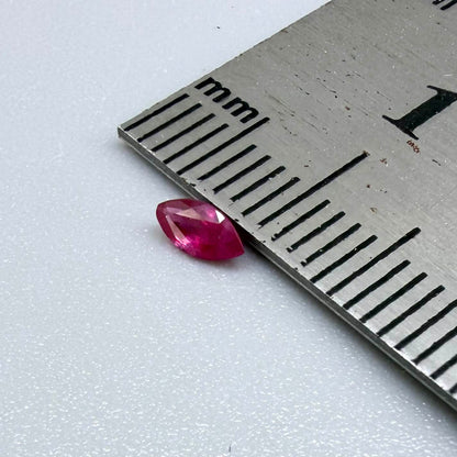 A marquise-cut pink-red ruby from Myanmar, 0.18 ct with eye-clean to slightly silky appearance