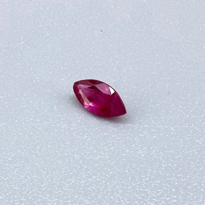 A marquise-cut pink-red ruby from Myanmar, 0.18 ct with eye-clean to slightly silky appearance
