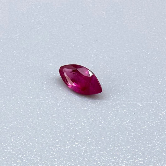 A marquise-cut pink-red ruby from Myanmar, 0.18 ct with eye-clean to slightly silky appearance