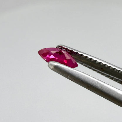 A marquise-cut pink-red ruby from Myanmar, 0.18 ct with eye-clean to slightly silky appearance