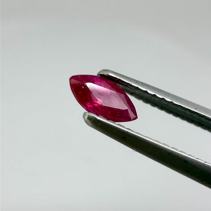 A marquise-cut pink-red ruby from Myanmar, 0.18 ct with eye-clean to slightly silky appearance