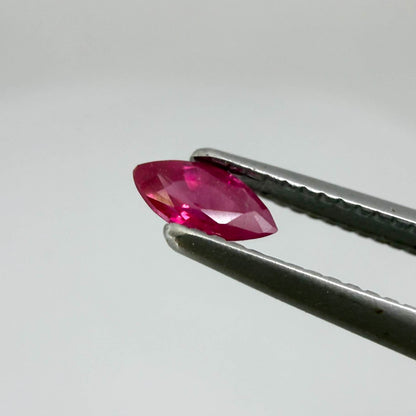 A marquise-cut pink-red ruby from Myanmar, 0.18 ct with eye-clean to slightly silky appearance