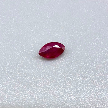 A faceted marquise-cut ruby with deep magenta-red coloration, 0.18 ct of weight with slightly silky appearance and fine natural inclusions