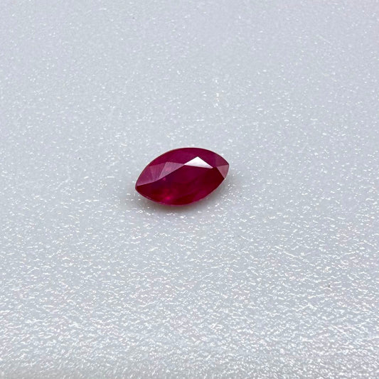 A faceted marquise-cut ruby with deep magenta-red coloration, 0.18 ct of weight with slightly silky appearance and fine natural inclusions