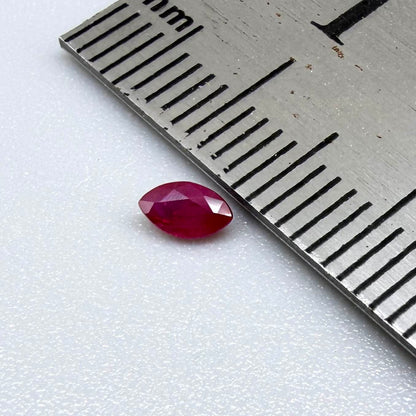 A faceted marquise-cut ruby with deep magenta-red coloration, 0.18 ct of weight with slightly silky appearance and fine natural inclusions