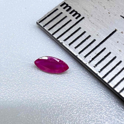 A marquise-cut ruby with a deep magenta-red hue, 0.17 ct of weight with slightly silky appearance and natural inclusions