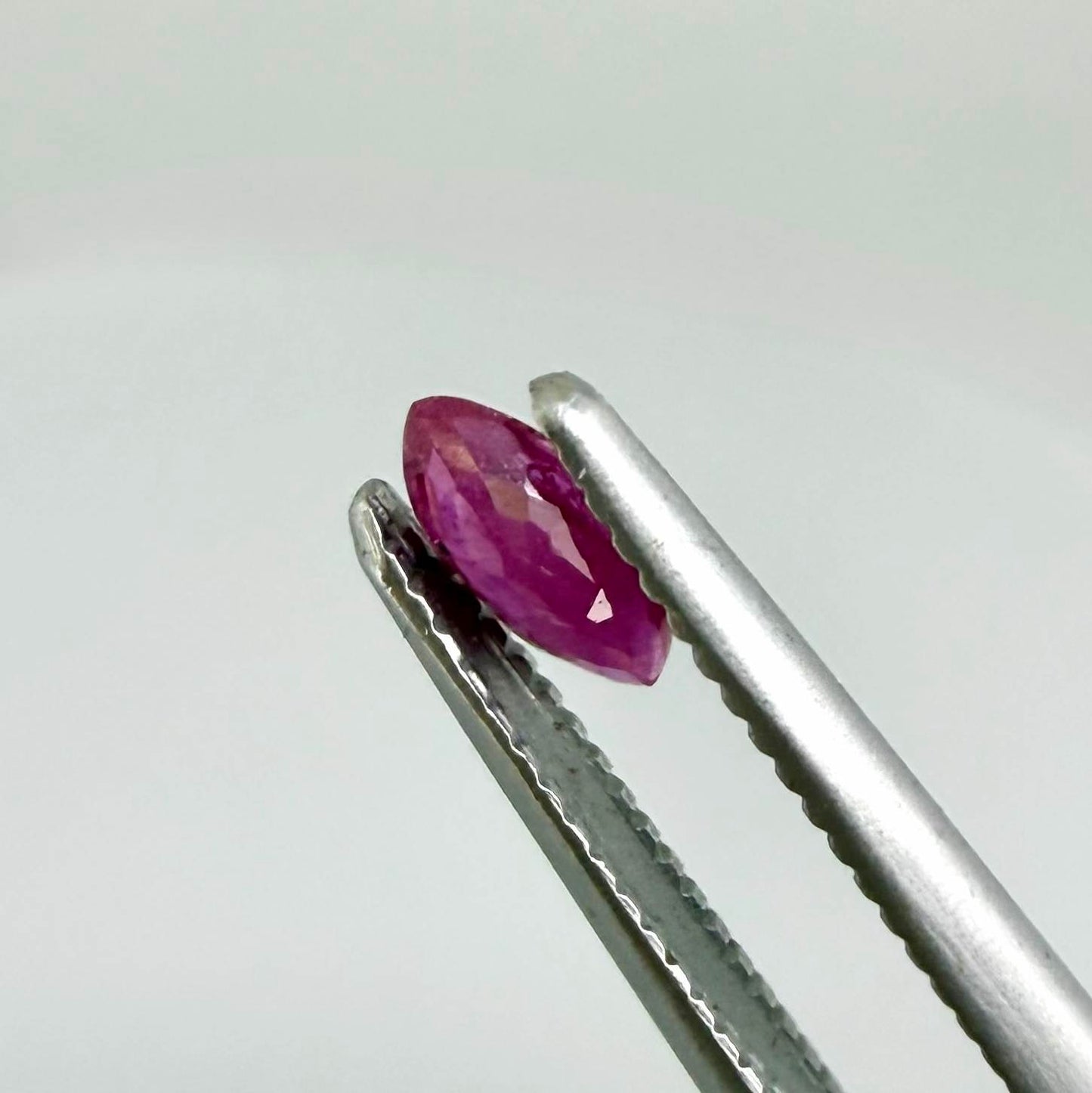 A marquise-cut ruby with a deep magenta-red hue, 0.17 ct of weight with slightly silky appearance and natural inclusions