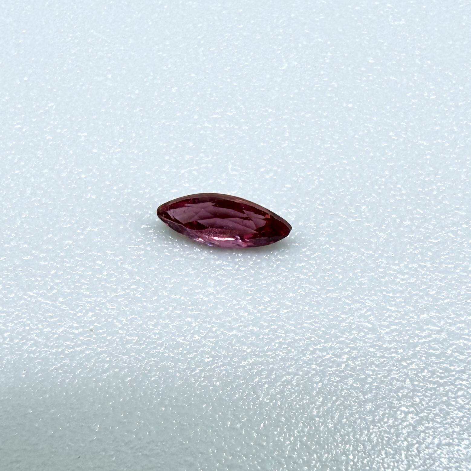 A marquise-cut deep pinkish-red ruby from Myanmar, 0.17 ct with eye-clean appearance and with fine natural inclusions