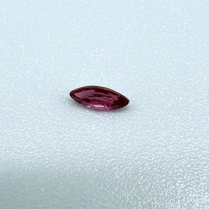 A marquise-cut deep pinkish-red ruby from Myanmar, 0.17 ct with eye-clean appearance and with fine natural inclusions