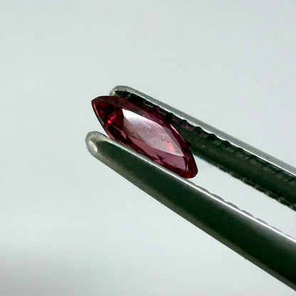 A marquise-cut deep pinkish-red ruby from Myanmar, 0.17 ct with eye-clean appearance and with fine natural inclusions