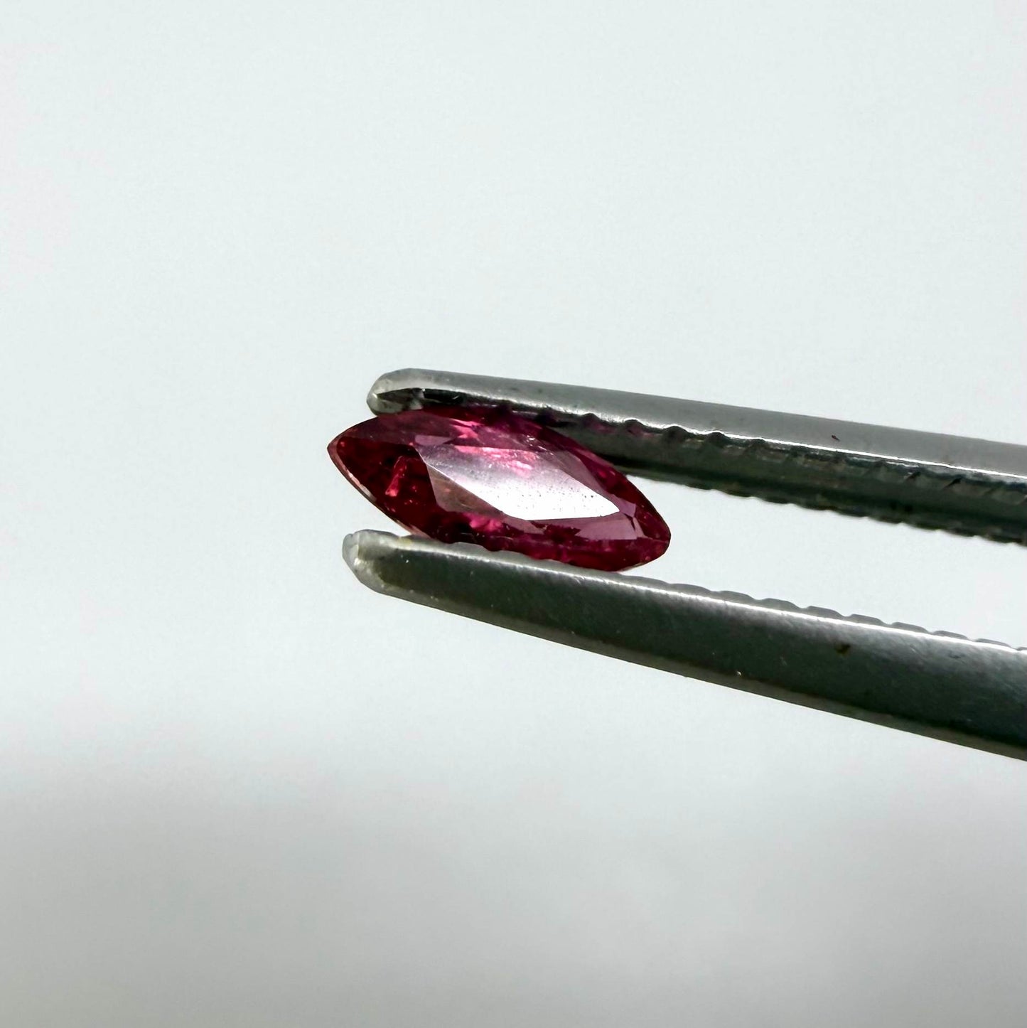 A marquise-cut deep pinkish-red ruby from Myanmar, 0.17 ct with eye-clean appearance and with fine natural inclusions