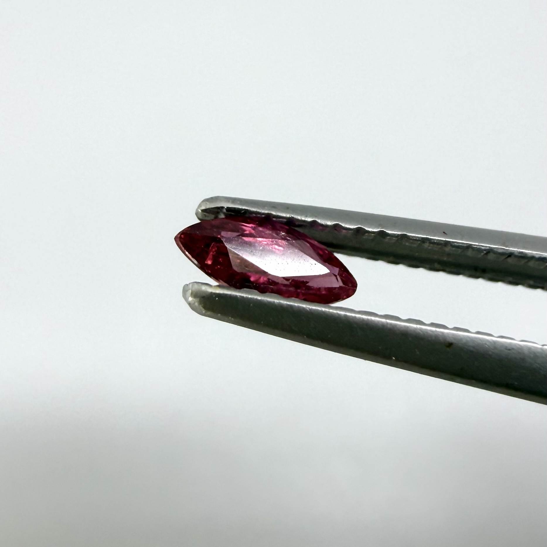 A marquise-cut deep pinkish-red ruby from Myanmar, 0.17 ct with eye-clean appearance and with fine natural inclusions