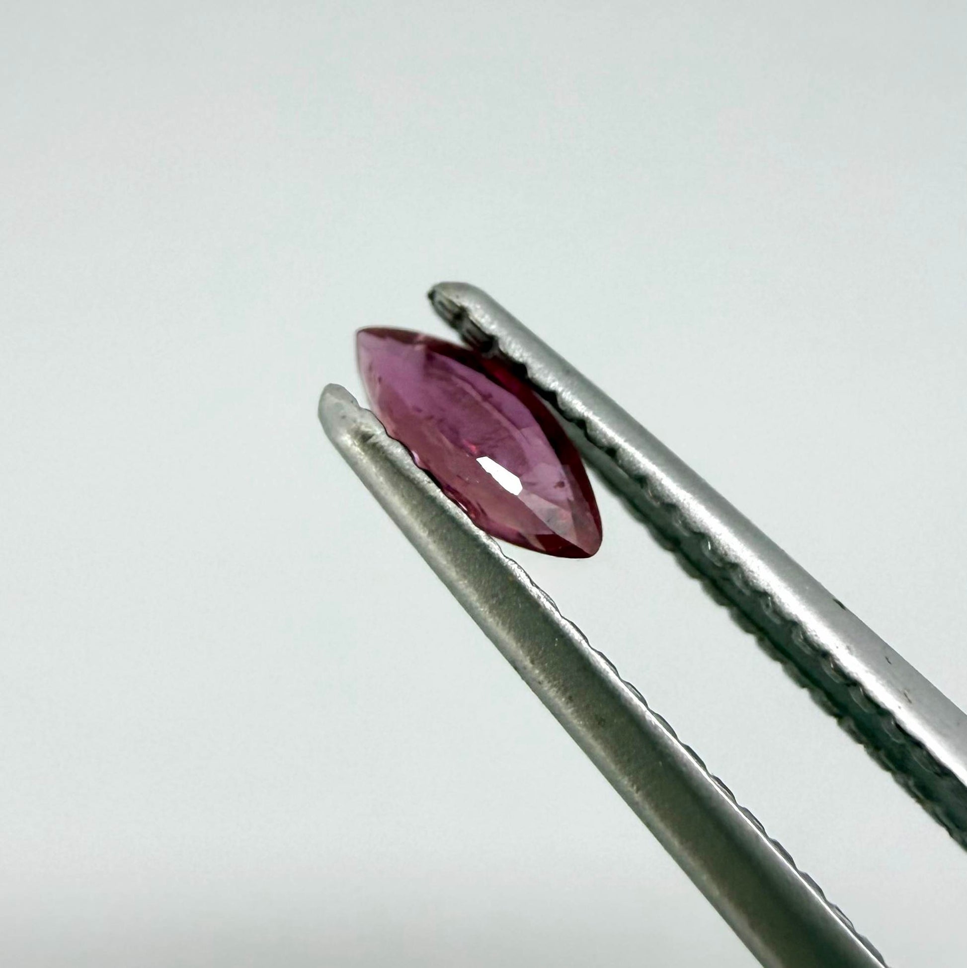 A marquise-cut deep pinkish-red ruby from Myanmar, 0.17 ct with eye-clean appearance and with fine natural inclusions