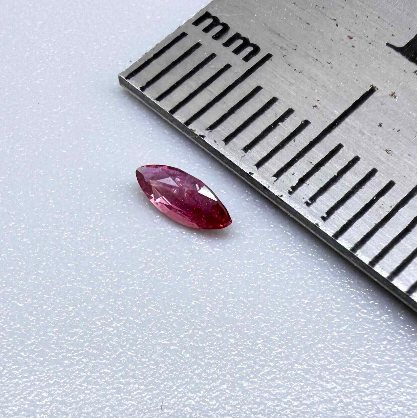 A marquise-cut deep pinkish-red ruby from Myanmar, 0.17 ct with eye-clean appearance and with fine natural inclusions