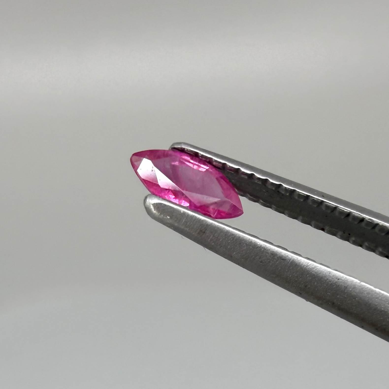 A small marquise-cut pink ruby from Myanmar, 0.16 ct, eye-clean appearance with fine natural inclusions