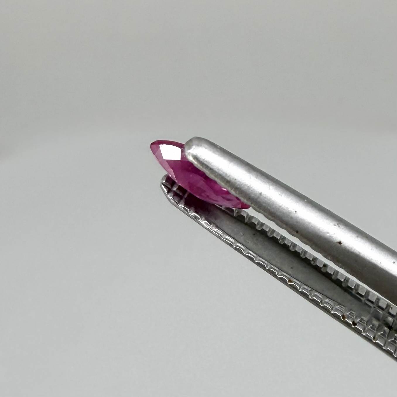 A small marquise-cut pink ruby from Myanmar, 0.16 ct, eye-clean appearance with fine natural inclusions