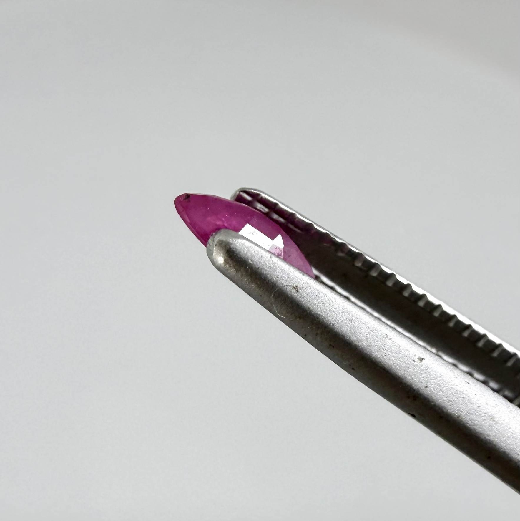 A faceted marquise-cut pink ruby from Myanmar, 0.16 ct, eye-clear to slightly silky appearance  with fine natural inclusions