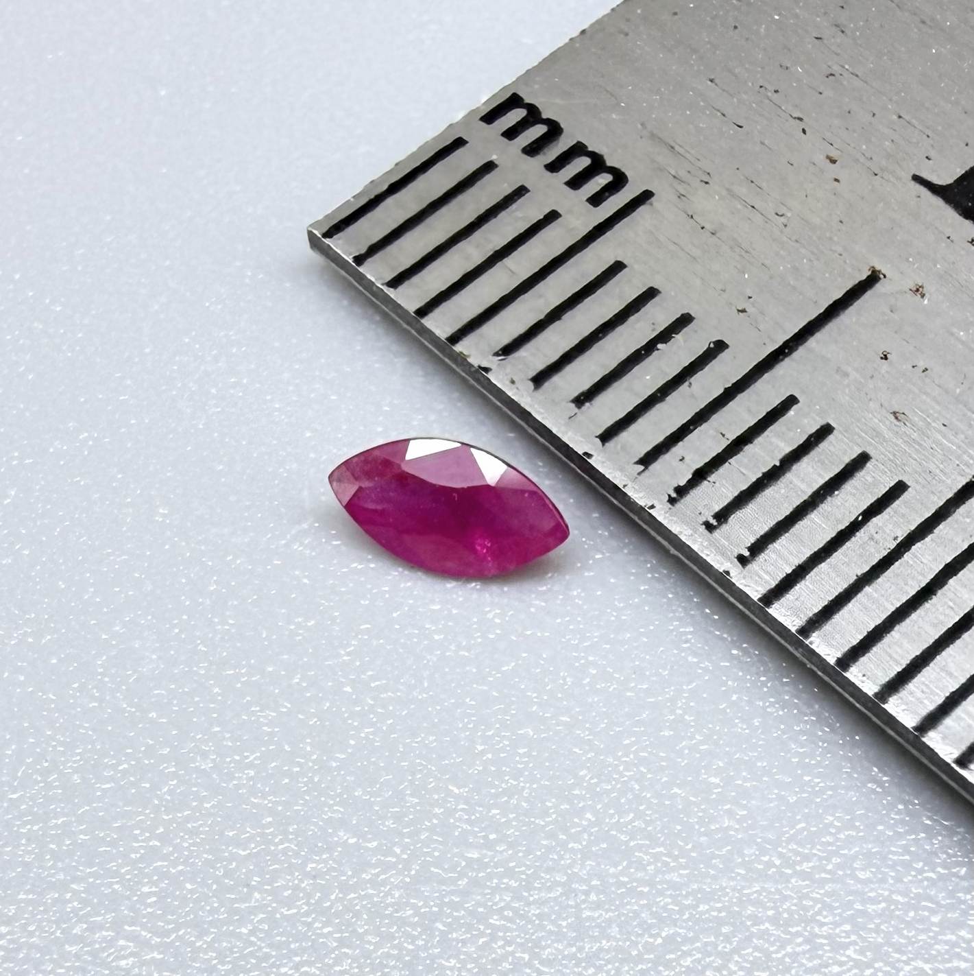A faceted marquise-cut pink ruby from Myanmar, 0.16 ct, eye-clear to slightly silky appearance  with fine natural inclusions
