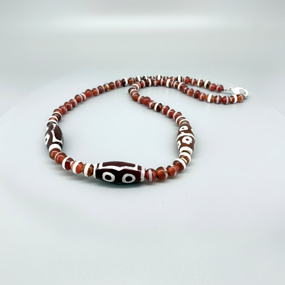 Handcrafted agate necklace with reddish-brown beads and patterned focal bead, 50 cm.