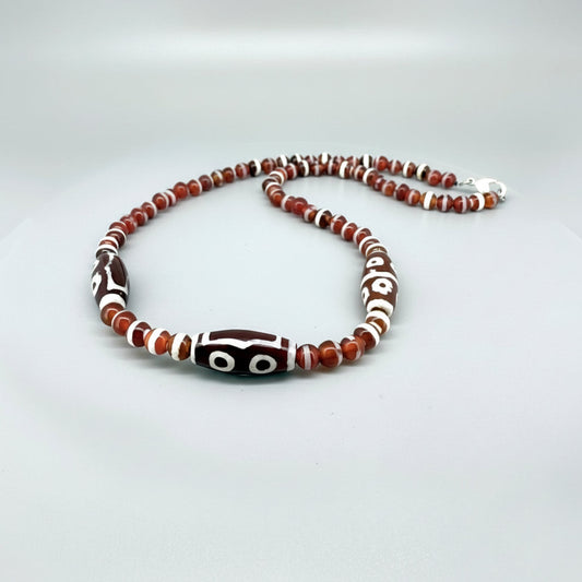 Handcrafted agate necklace with reddish-brown beads and patterned focal bead, 50 cm.