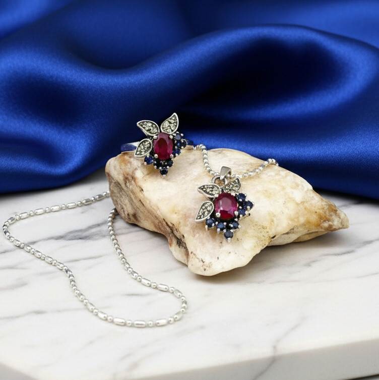 Sterling silver ring featuring a natural ruby at the center, accented by sapphires and peridot in a colorful gemstone cluster design.