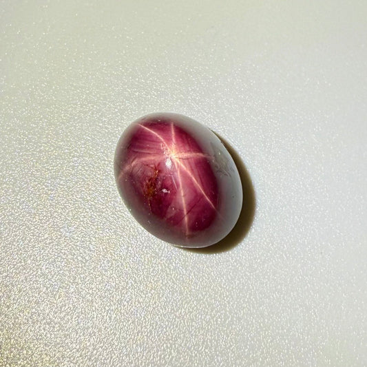19 ct natural Wine-Red Star Ruby cabochon from Mozambique with soft star effect and polished dome.