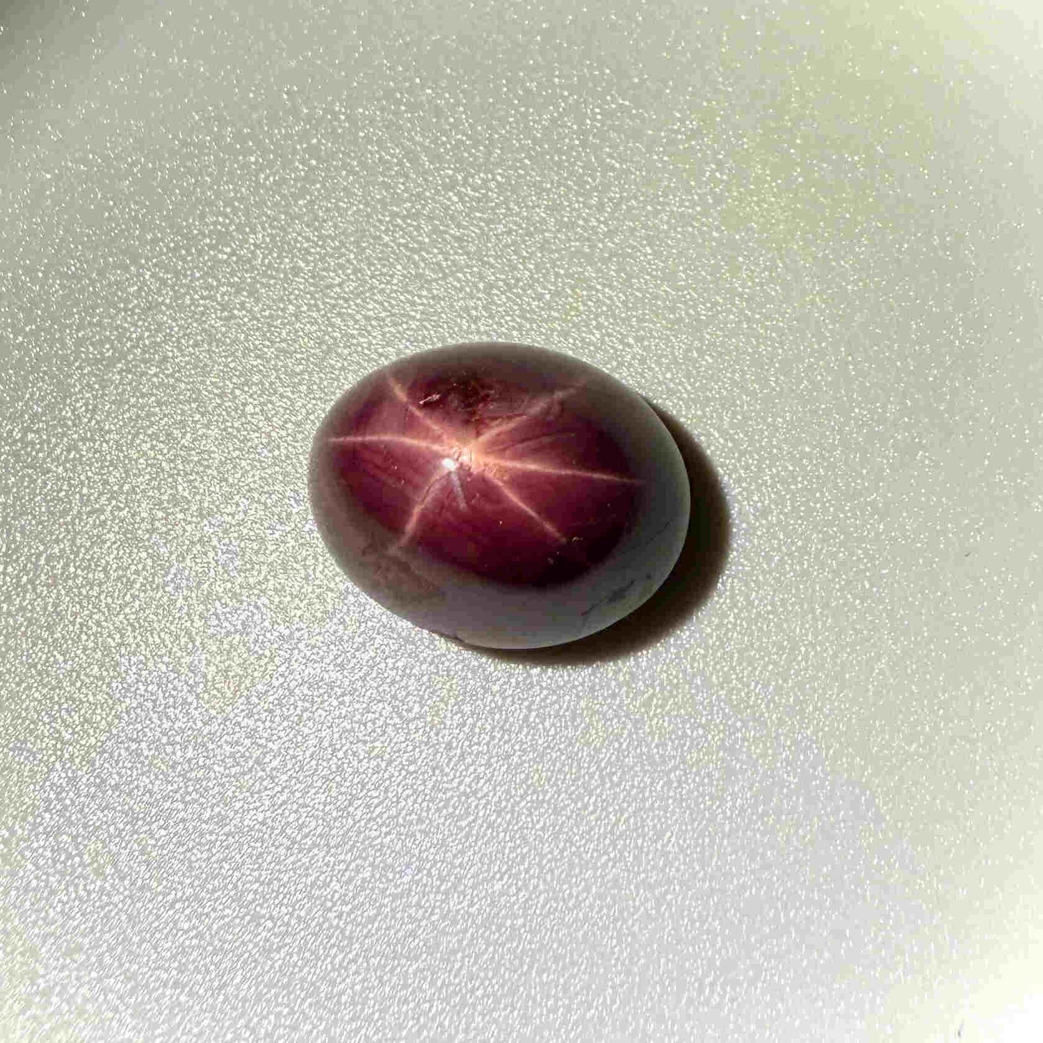19 ct natural wine-red Star Ruby cabochon with soft star effect and polished dome.