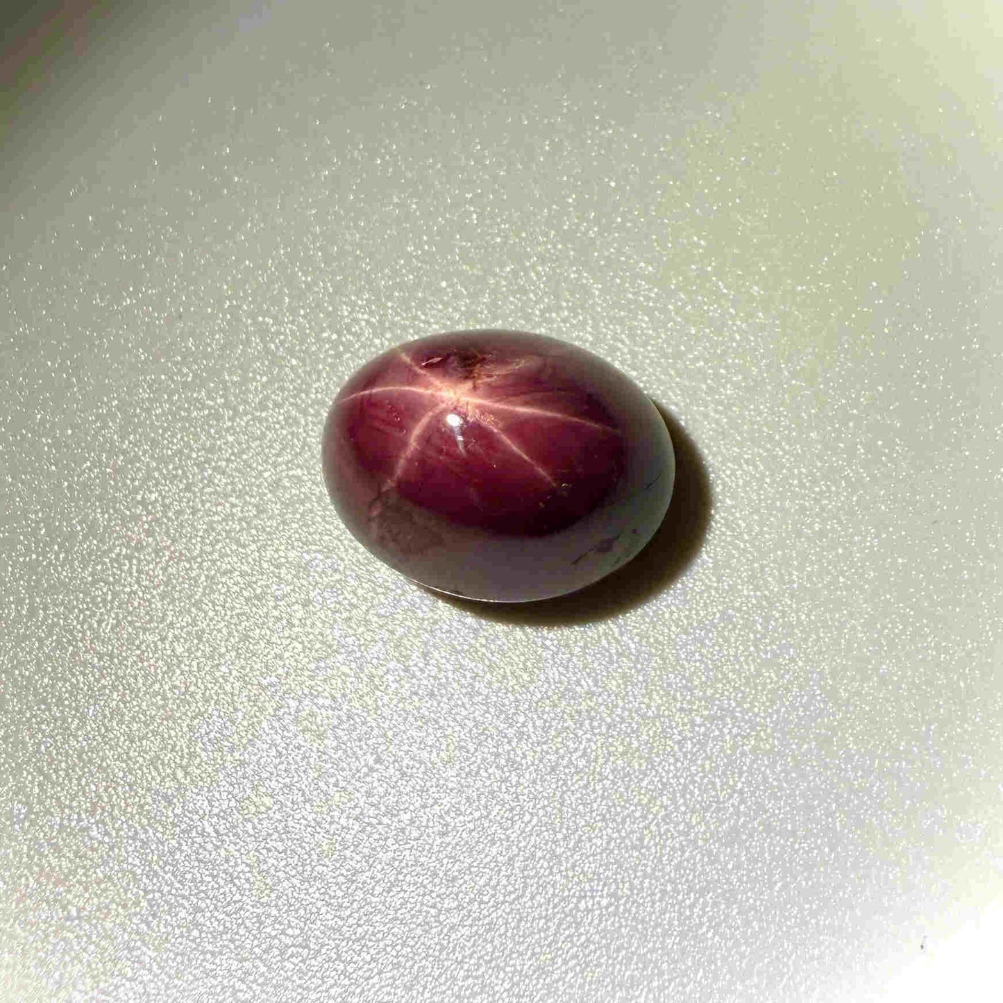 19 ct natural wine-red Star Ruby cabochon with soft star effect and polished dome.