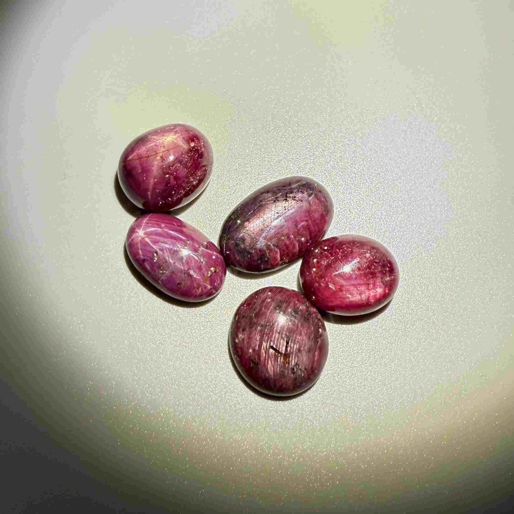 150.4 ct natural Star Ruby lot from Madagascar with polished cabochons and soft star effects.