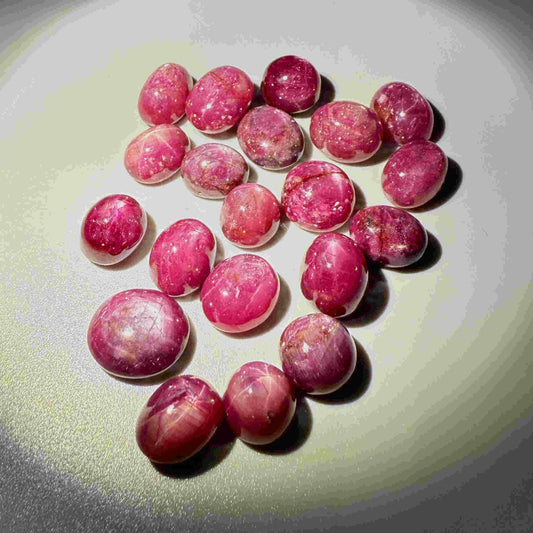 346.8 ct natural Star Ruby lot from Madagascar featuring multiple polished cabochons with soft star effects.