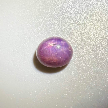 3.94 ct natural pink-purple Star Ruby cabochon from Madagascar with soft star effect and polished dome.