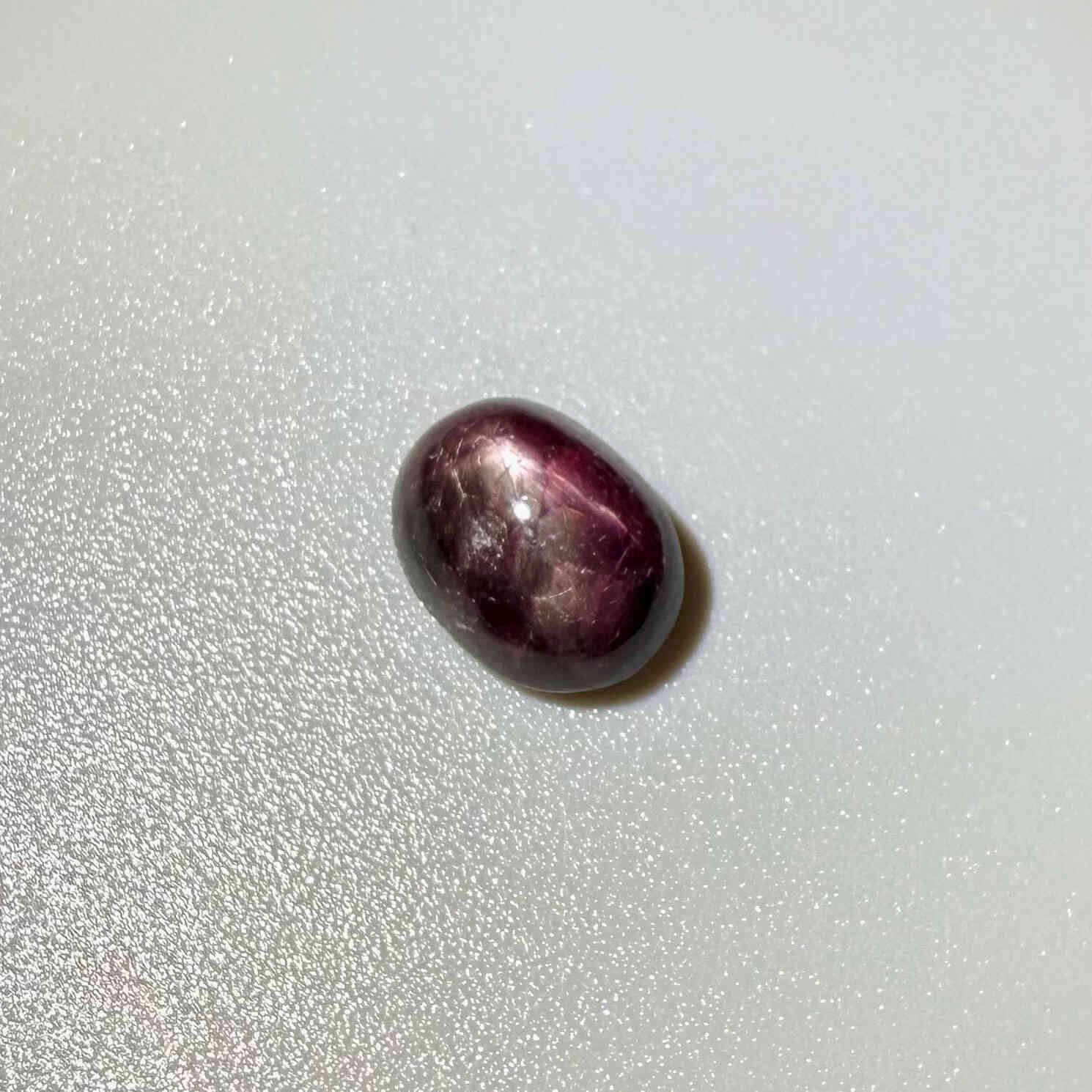 4.67 ct natural bordeaux-red Star Ruby cabochon with soft star effect and polished dome.