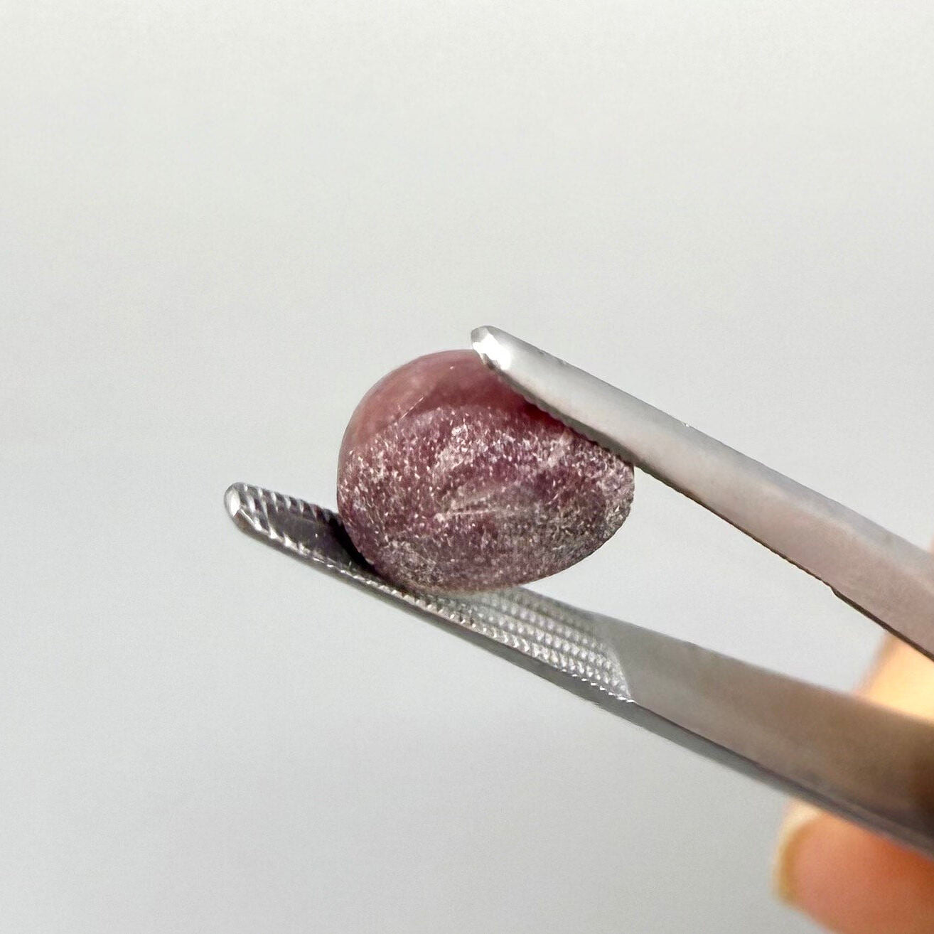 3.13 ct natural pinkish-red Star Ruby cabochon with soft star effect and polished dome.