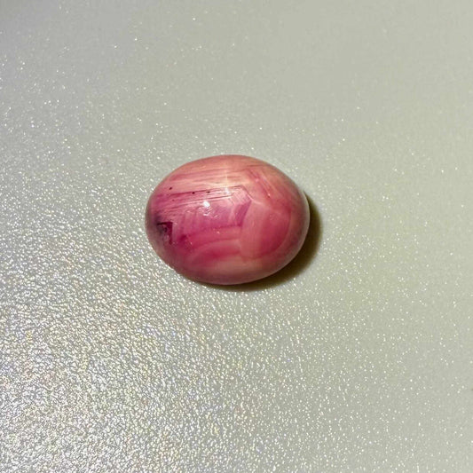 5.52 ct natural pink Star Ruby cabochon with soft star effect and polished dome.