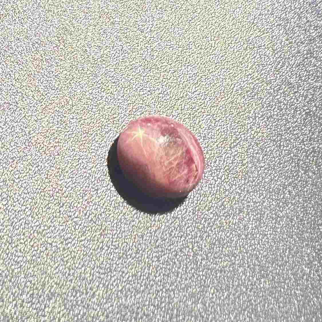 3.13 ct natural pinkish-red Star Ruby cabochon with soft star effect and polished dome.