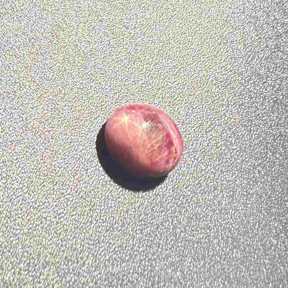 3.13 ct natural pinkish-red Star Ruby cabochon with soft star effect and polished dome.